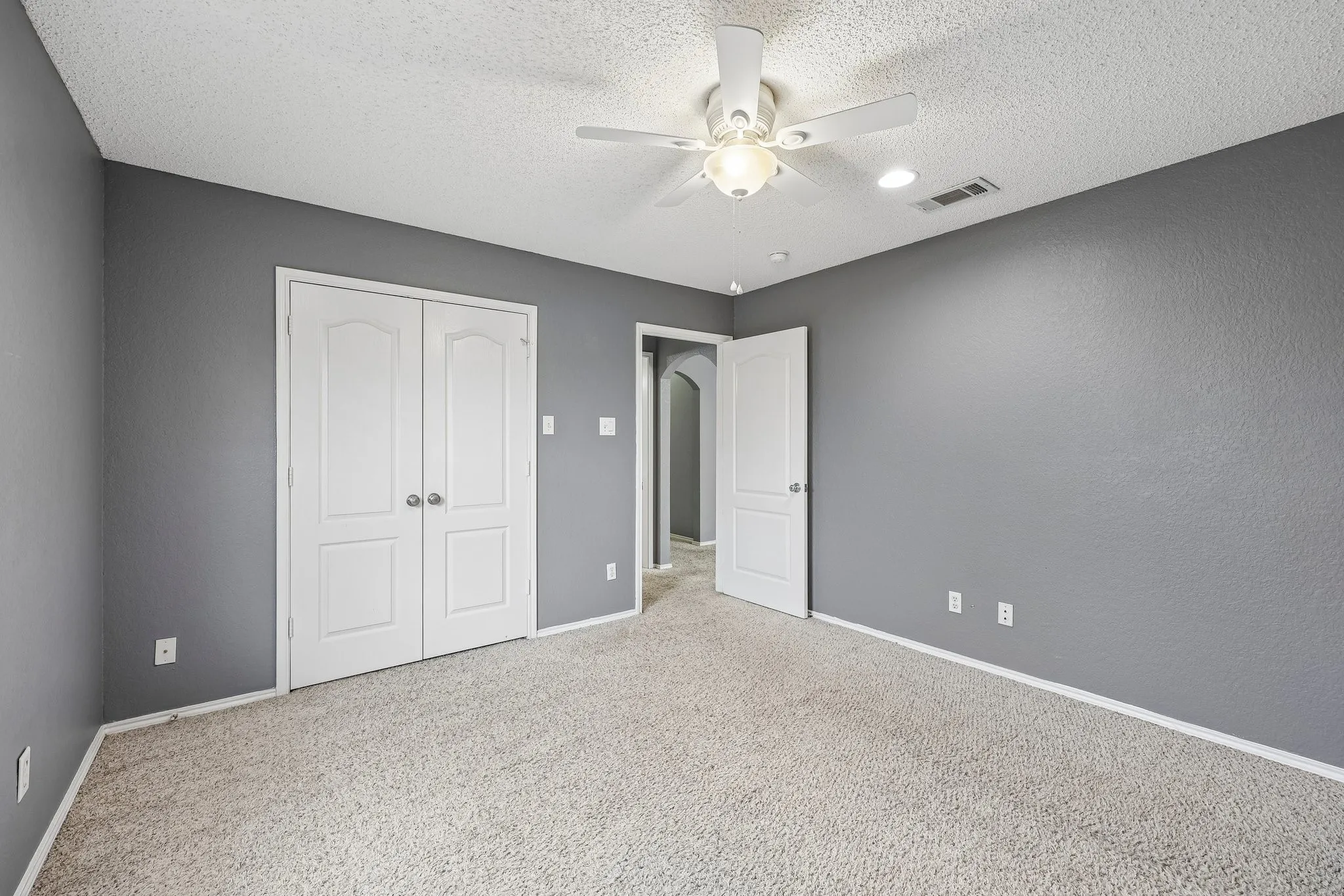 Interior room featuring gray walls and light-colored carpet flooring