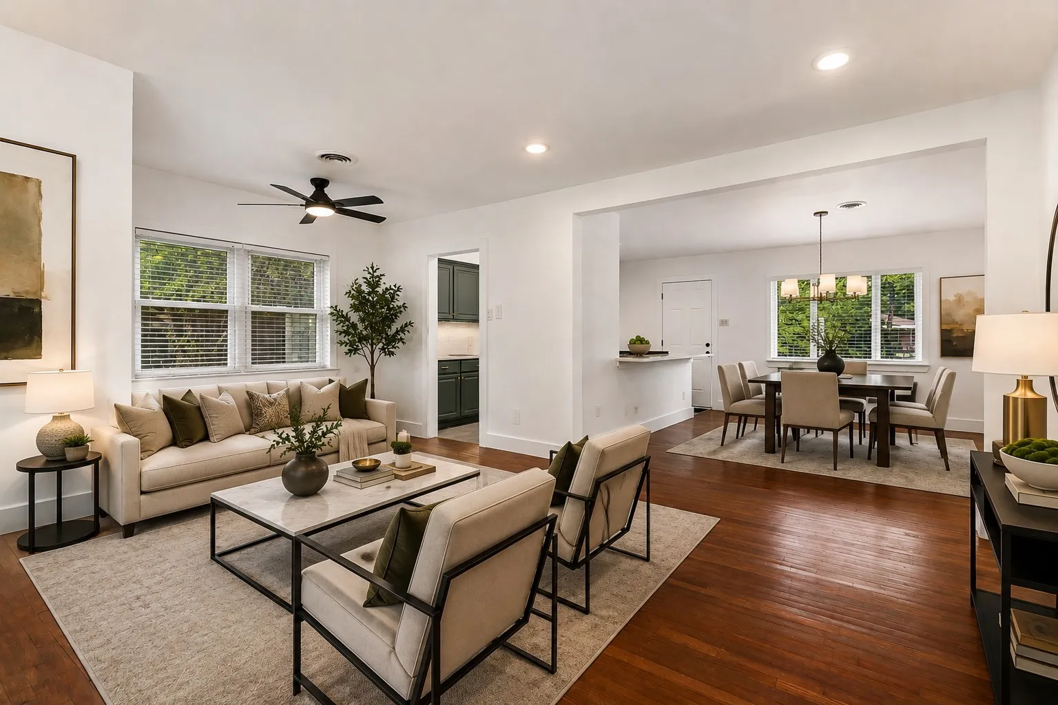 Designed for both comfort and effortless entertaining, this beautifully renovated living room welcomes you with an open-concept layout, rich hardwood flooring, and an abundance of natural light streaming through oversized windows. The spacious design creates an inviting atmosphere while seamlessly connecting  the main living area and dining