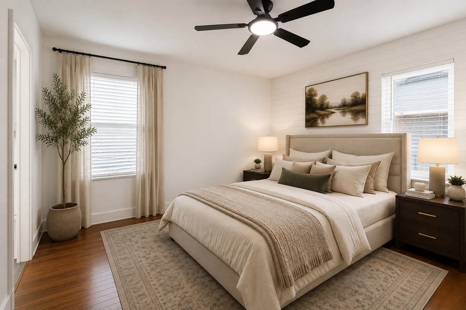 Rich hardwood floors, crisp white walls, and abundant natural light create a warm, inviting atmosphere