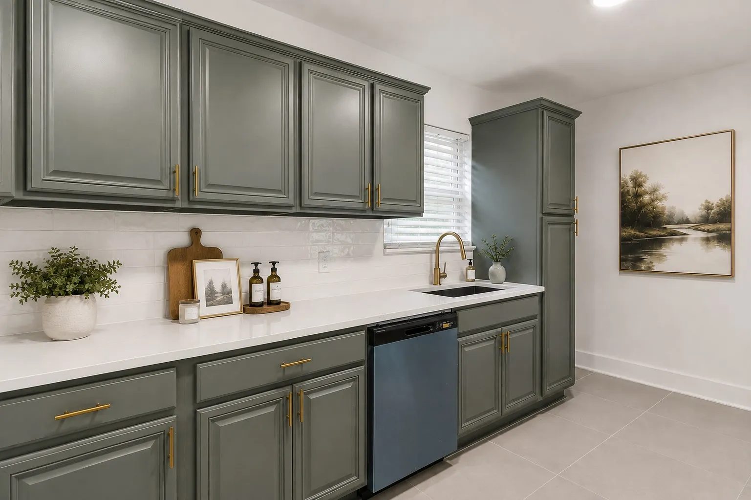 Designed with timeless elegance and everyday functionality, this beautiful updated kitchen showcases custom sage-green shaker cabinetry accented with brushed brass hardware sleek quartz countertops, and a classic white subway title backsplash. A spacious workstation provides generous prep space, while the premium stainless steel dishwasher, designer brushed gold faucet, and oversized pantry cabinet add both style and practicality