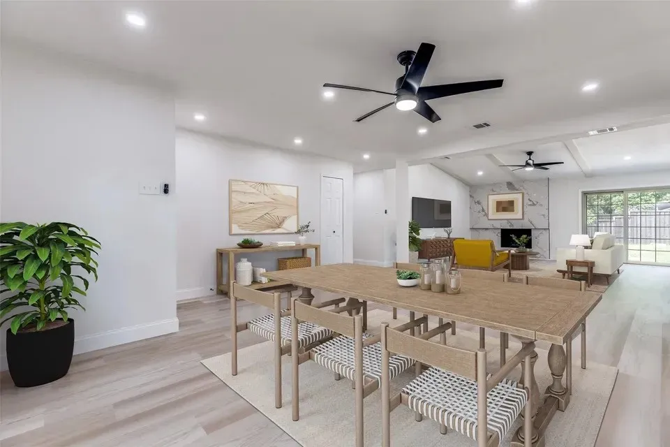 Open-concept interior featuring light wood-finish flooring, recessed lighting, and a modern ceiling fan