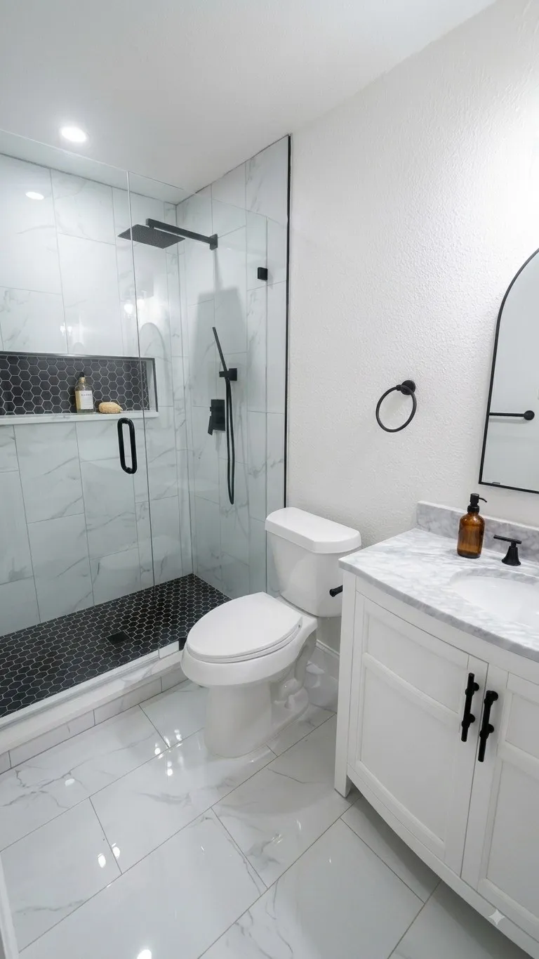 Glass-enclosed shower with matte black fixtures and a hexagonal tile floor