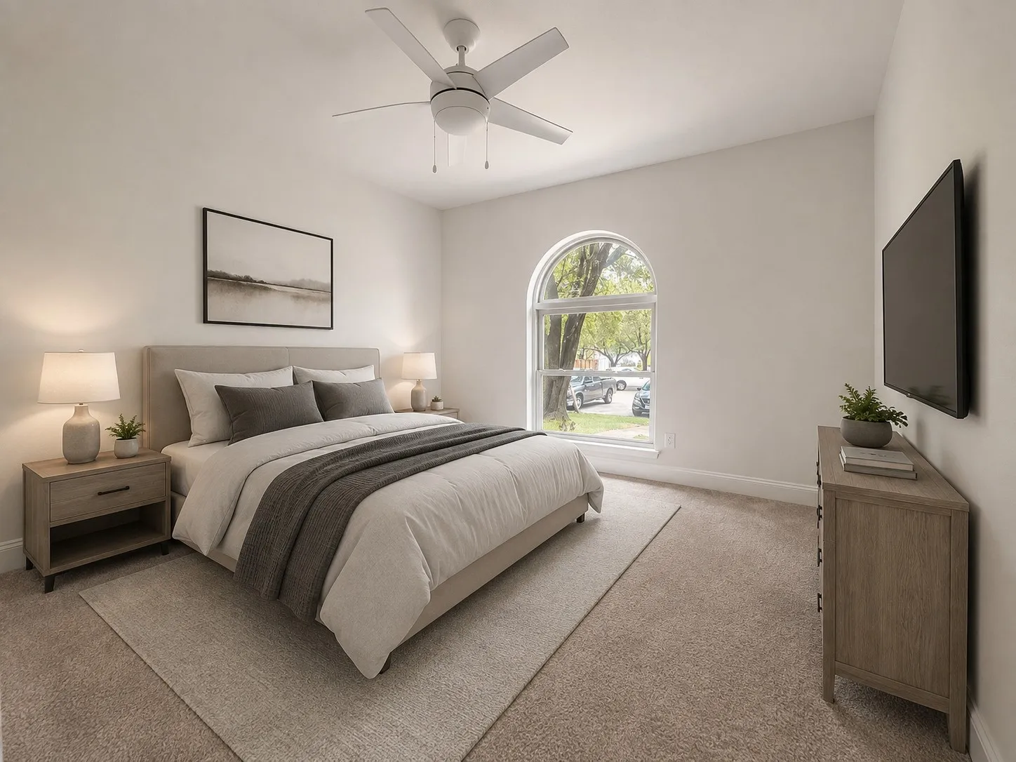 Arched window with exterior street perspective, ceiling fan with integrated lighting, carpeted flooring, and a wall-mounted flat screen television