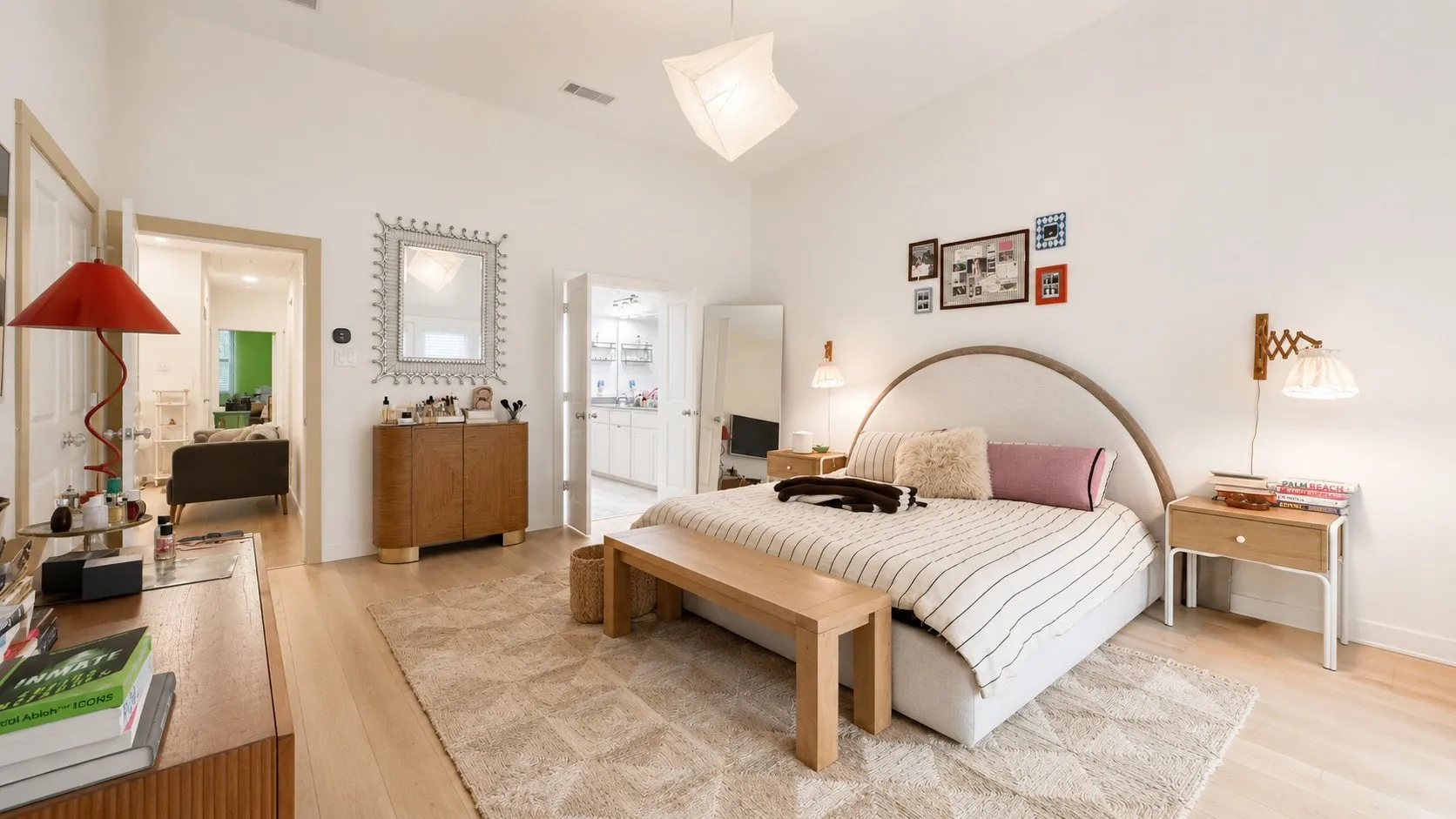 Spacious interior featuring high vaulted ceilings, light wood-finish flooring, and white painted walls