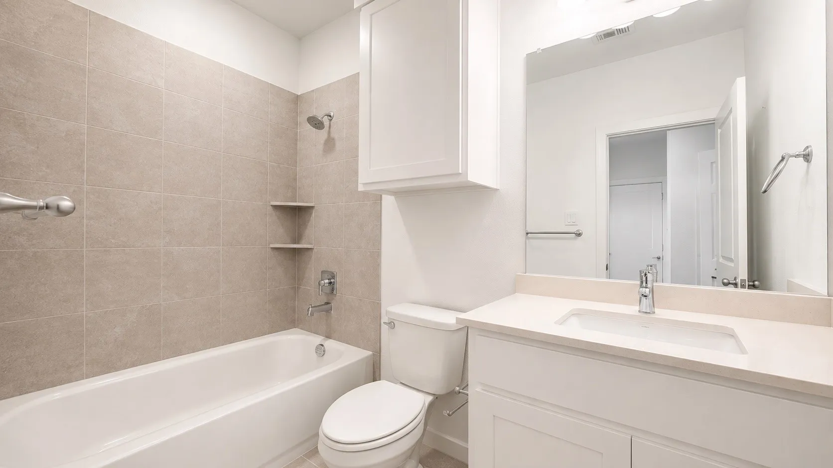 Modern bathroom featuring a clean-lined vanity with an integrated sink, quartz countertop, and chrome faucet