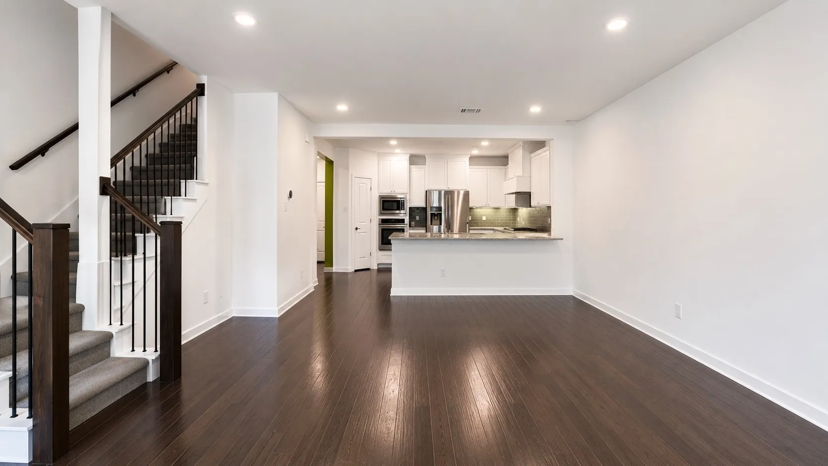Open-concept living area with dark wood-finish flooring