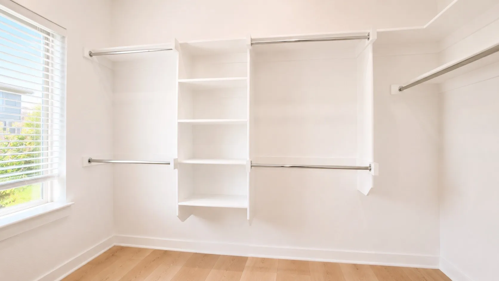 Spacious walk-in closet featuring custom built-in shelving and hanging rods, wood-finish flooring, and abundant natural light from a nearby​​‌​​​​‌​​‌‌​‌‌​​​‌‌​‌​‌​‌​​​‌​​ window