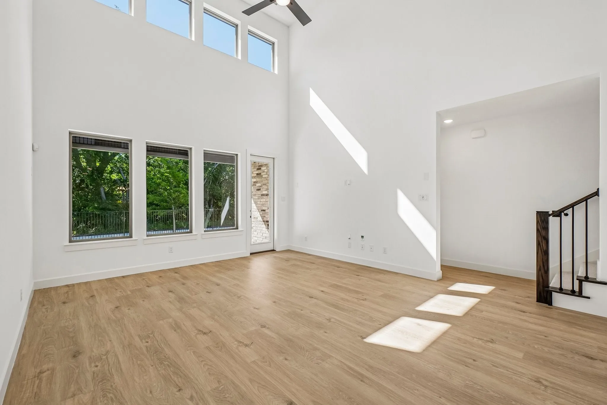 With a wall of dual stacked windows, the spacious family room is filled with natural light and offers a beautiful view of the greenbelt the backs to the home.