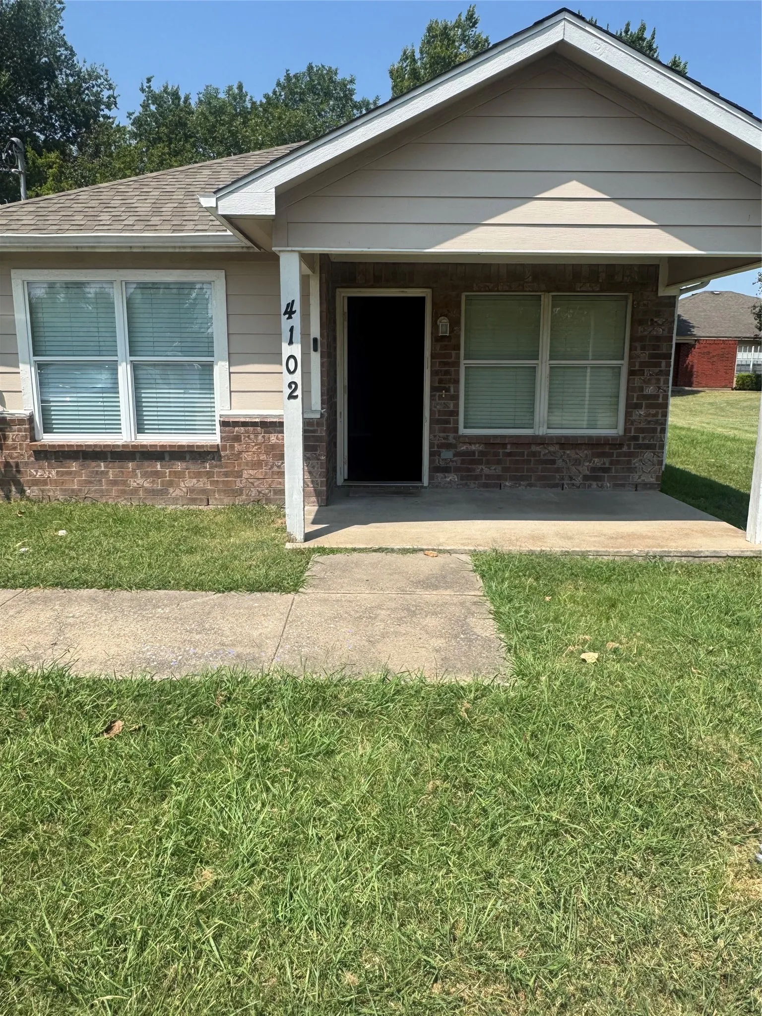 Brick and siding exterior with a covered entry