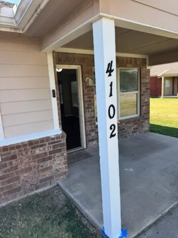 Covered concrete porch with brick and siding​​‌​​​​‌​​‌‌​‌‌​​​‌‌​‌​‌​‌​​​‌​​ exterior