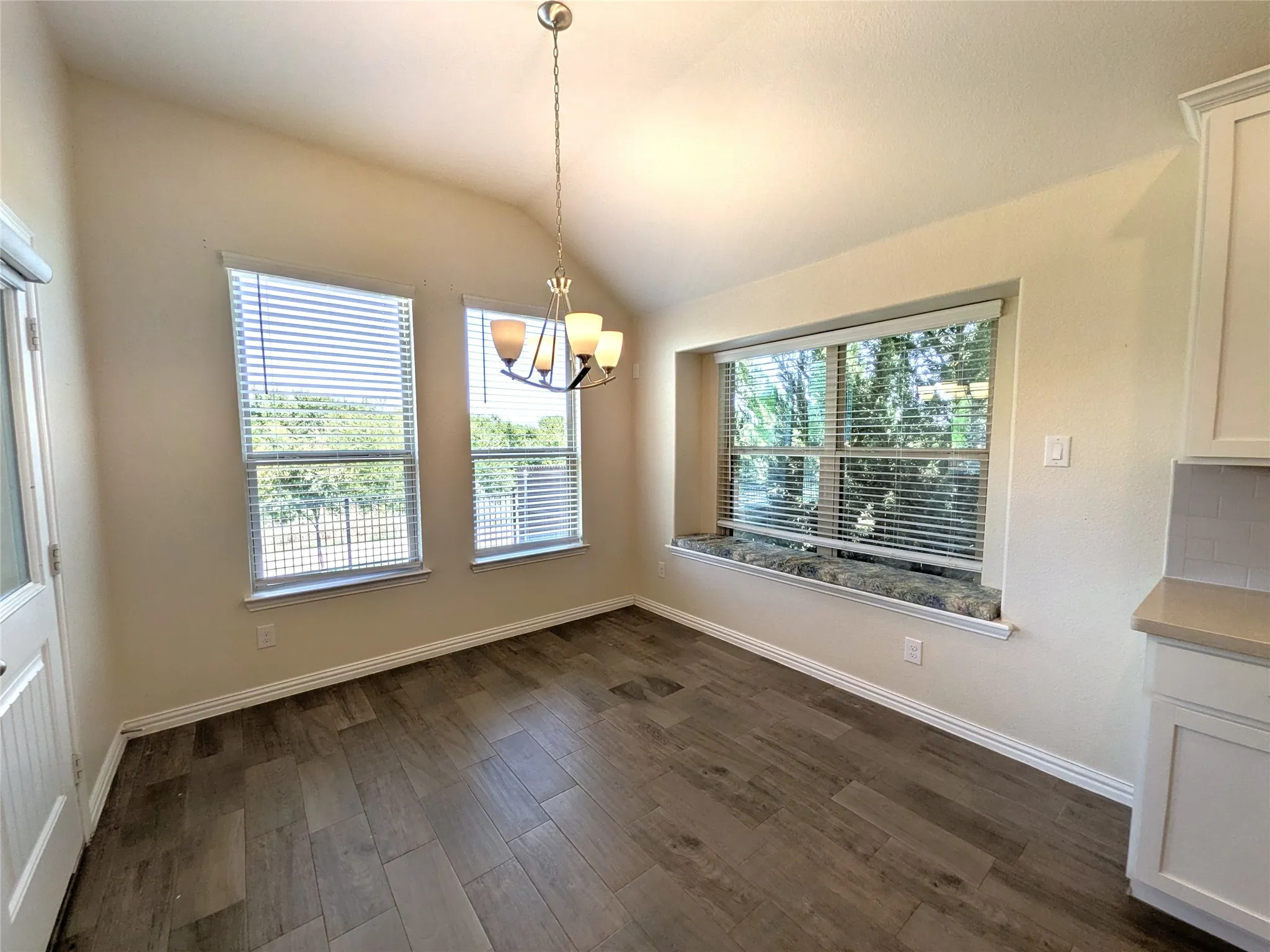 Bright and spacious dining area bathed in natural light from multiple large windows