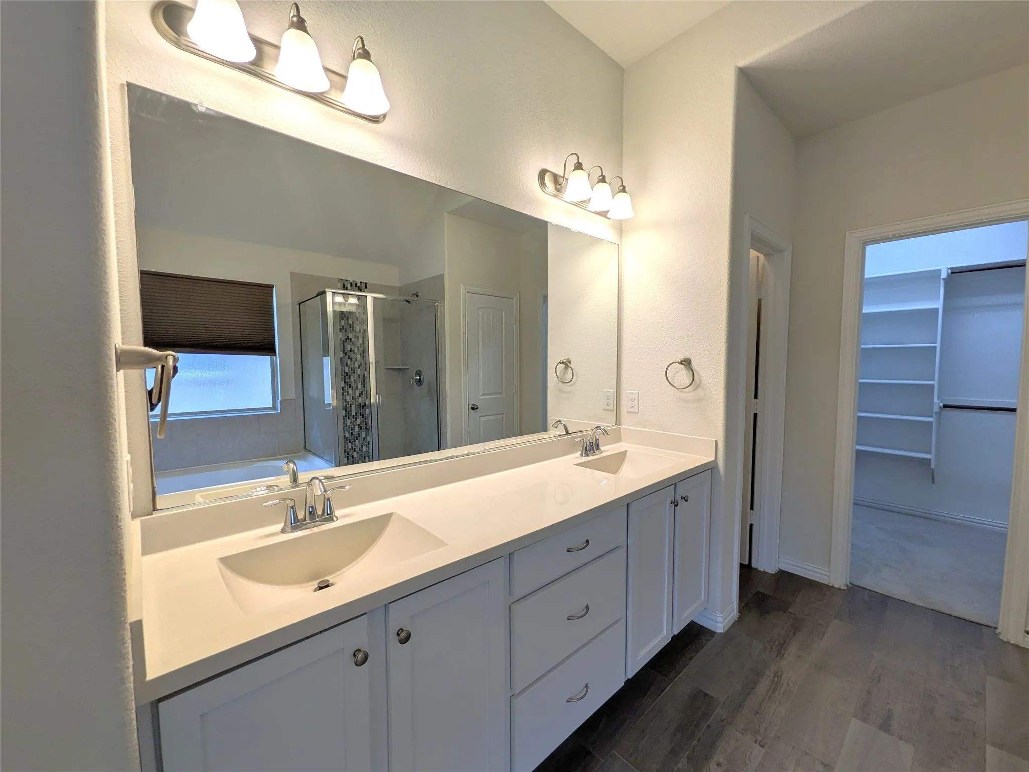 Dual-sink vanity with soft-close cabinetry, quartz countertop, and chrome fixtures
