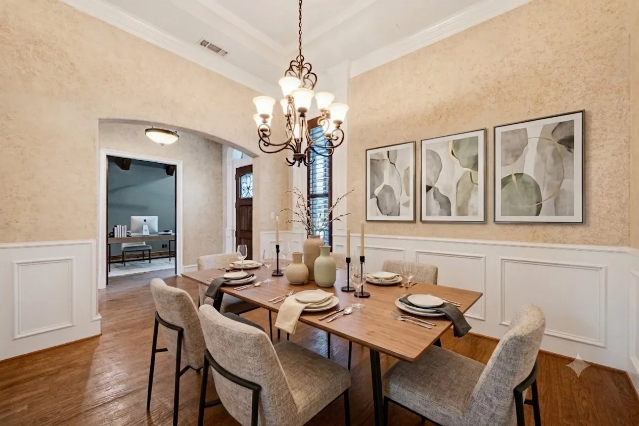 Virtually staged. Formal dining area featuring hardwood flooring, wainscoting, an arched entryway, and a tray ceiling with an ornate chandelier