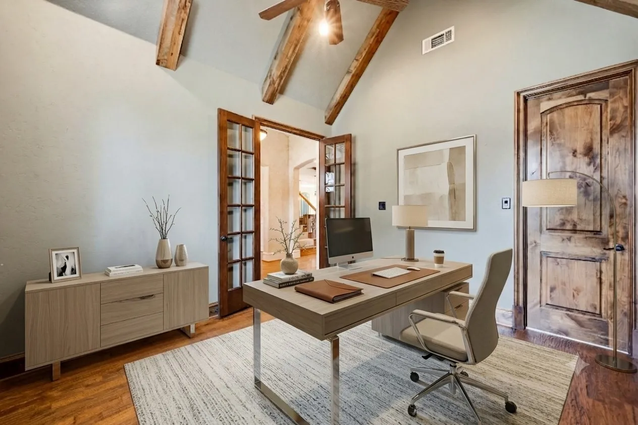 Virtually staged. Vaulted ceiling with exposed wood beams, wood-finish flooring, french doors, and a solid wood panel door