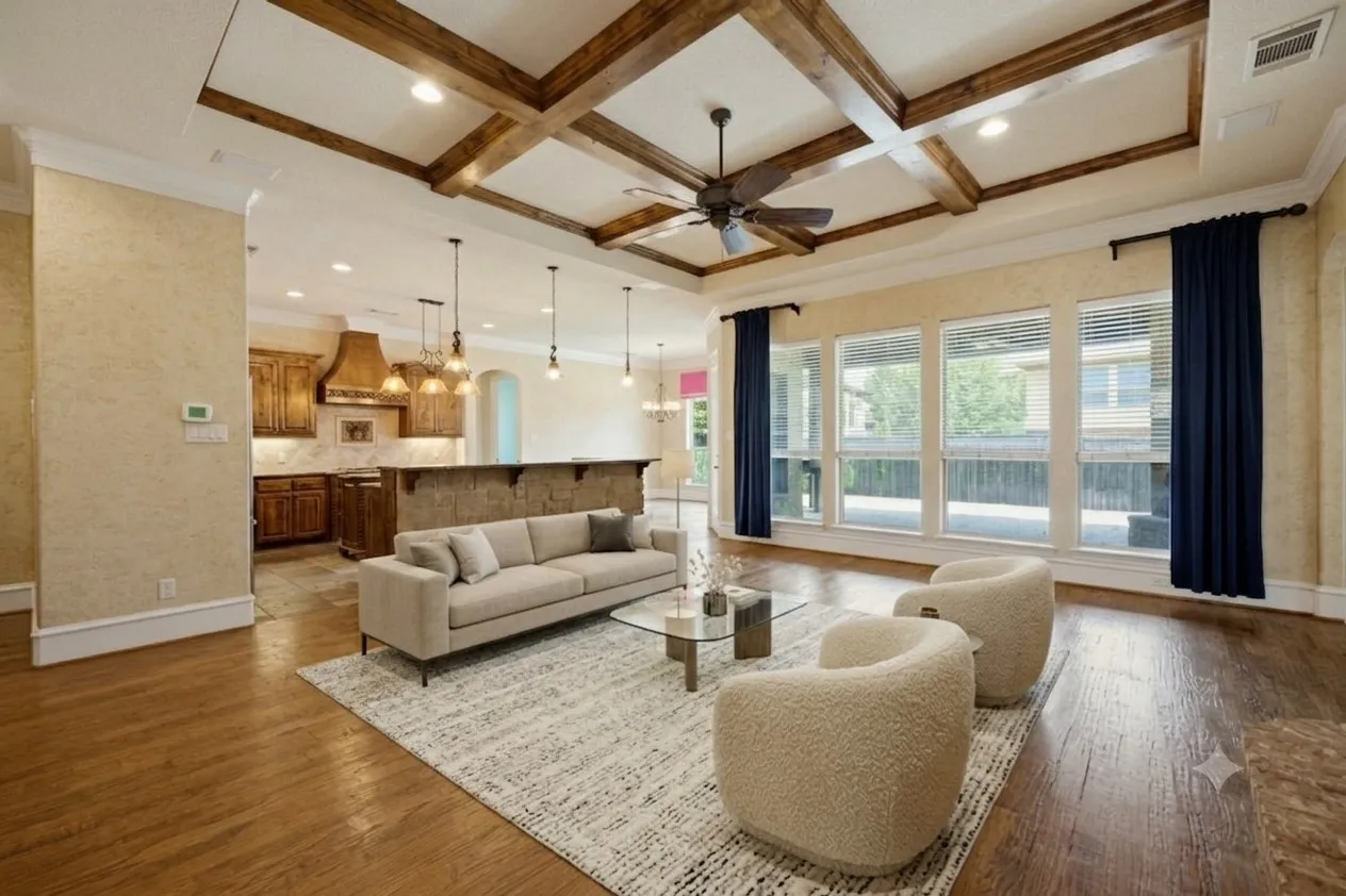 Virtually staged. Living area featuring a coffered ceiling with wood beams, recessed lighting, and a ceiling fan
