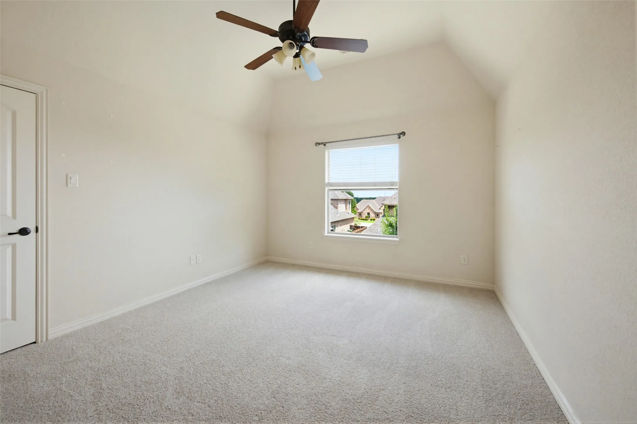 2nd level Spacious bedroom featuring neutral carpet flooring, ceiling fan with integrated lighting, and a window with natural light and exterior views