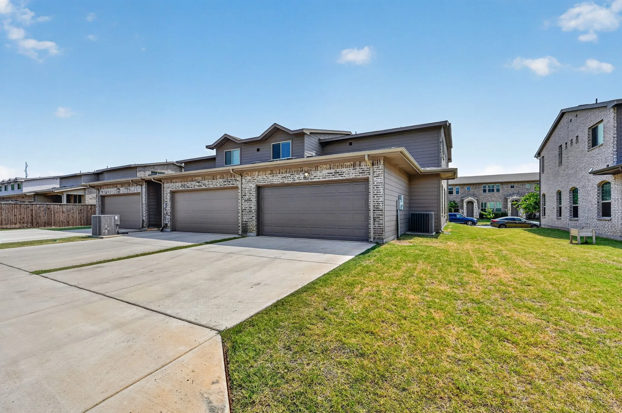 Townhome exterior featuring brick and siding finishes