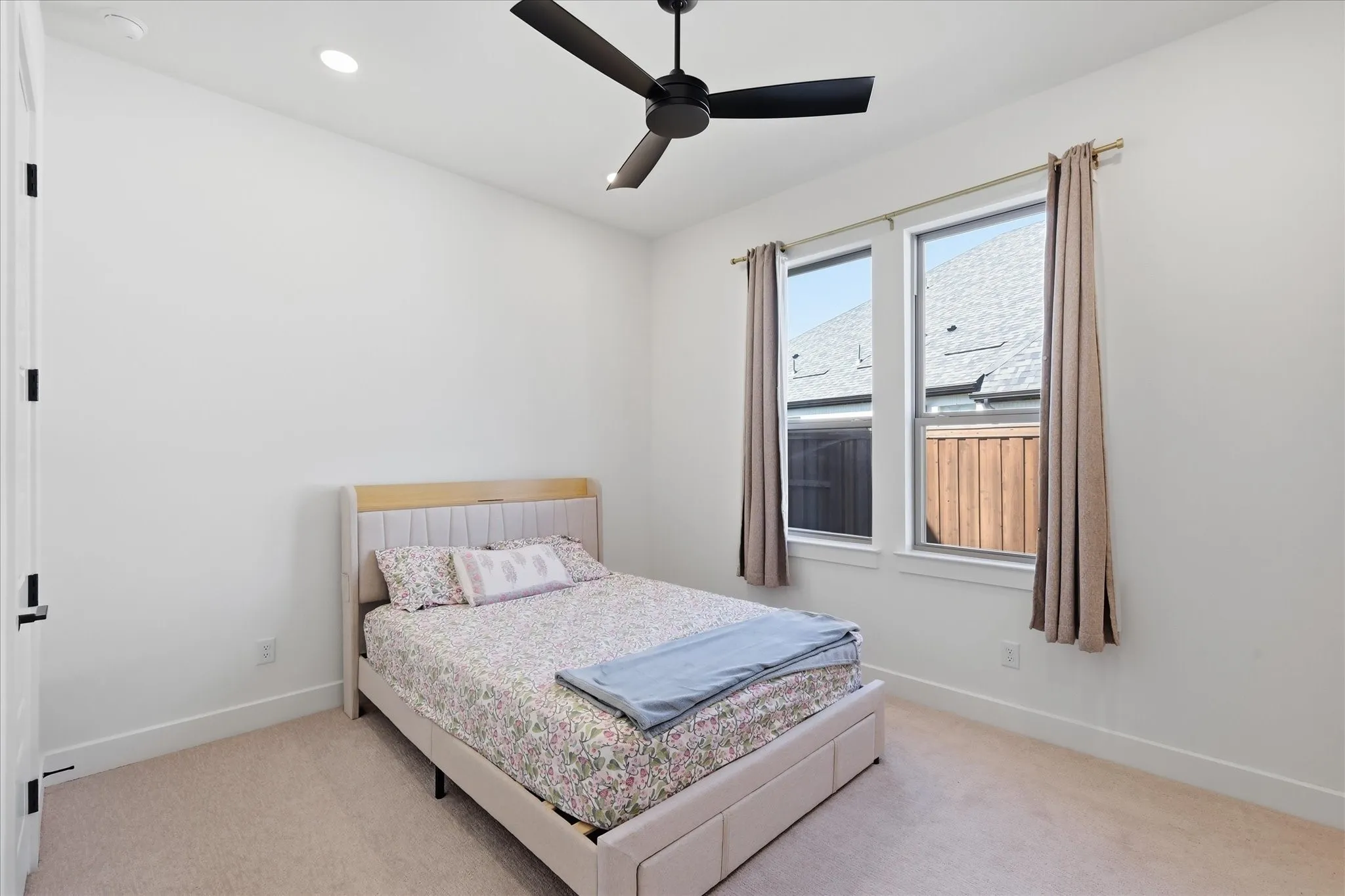 Recessed lighting, ceiling fan, double pane windows, and neutral carpeting