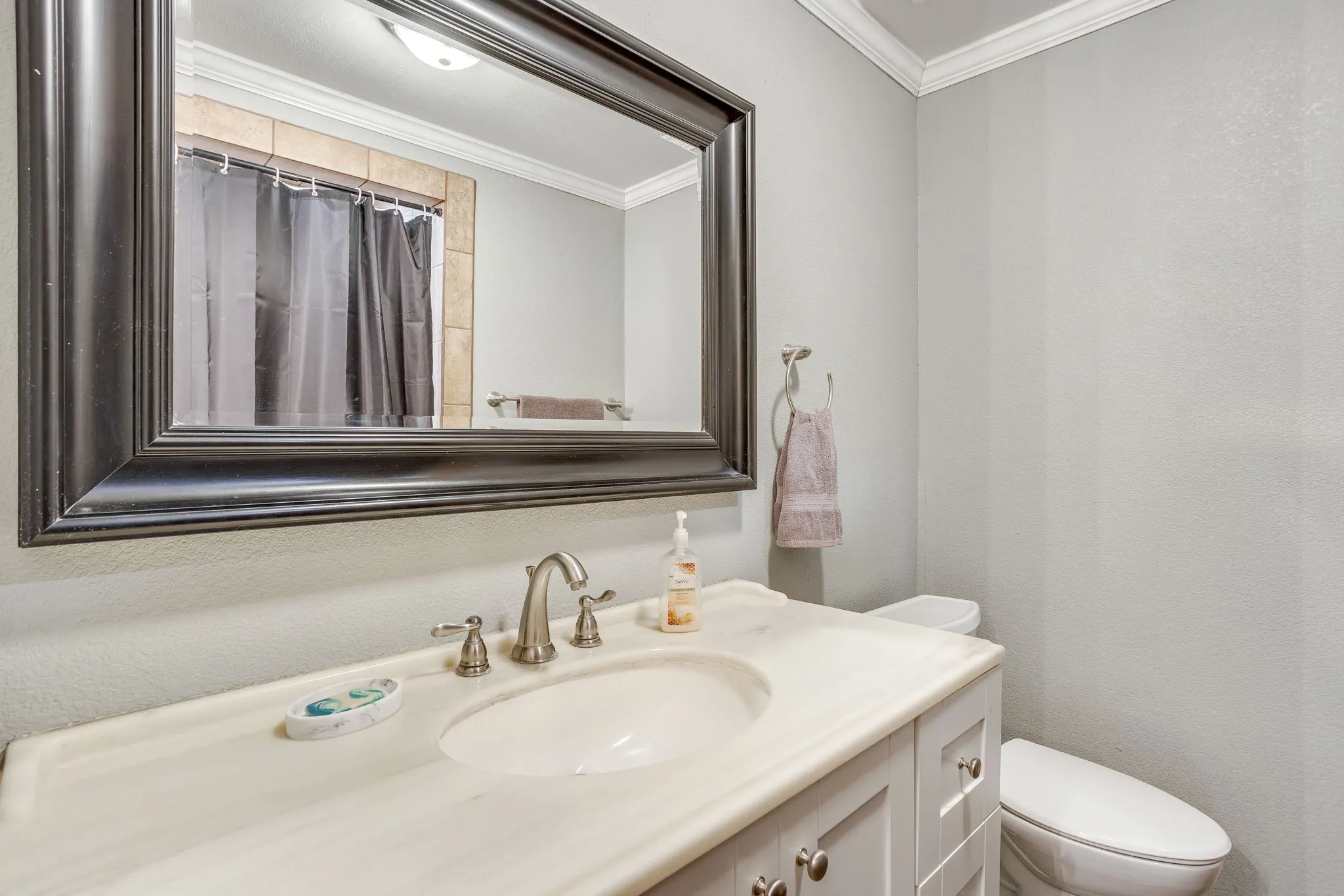 Bathroom vanity with a white countertop and undermount sink