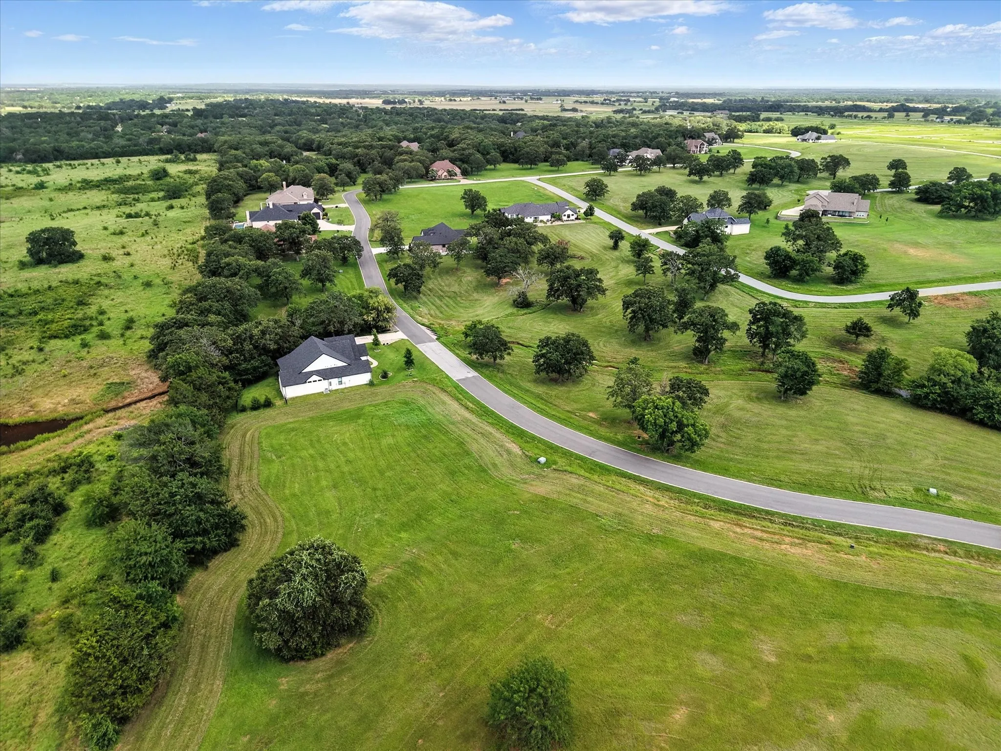 Sprawling rural estate featuring multiple residences set across expansive manicured grounds