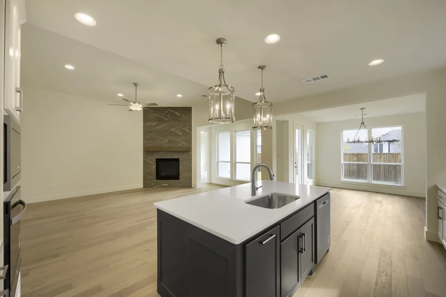 Kitchen island with a built-in sink and pendant lighting