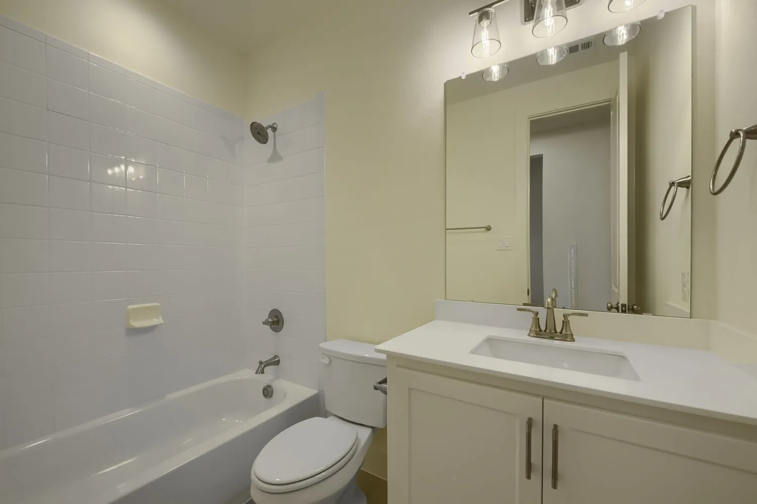 White subway tile shower surround with a built-in bathtub