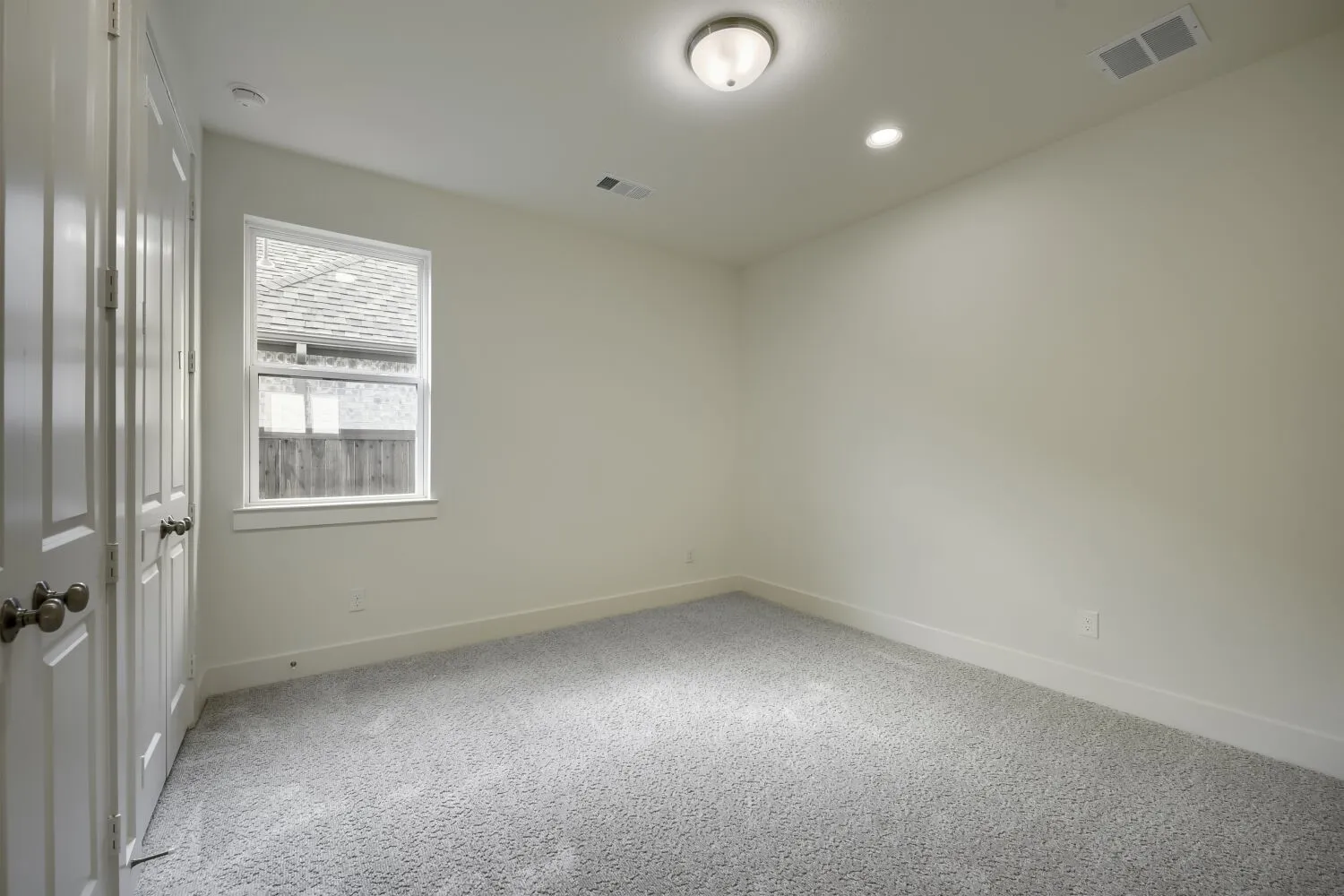 Light-filled room featuring carpet flooring, crisp white walls, and a recessed ceiling light