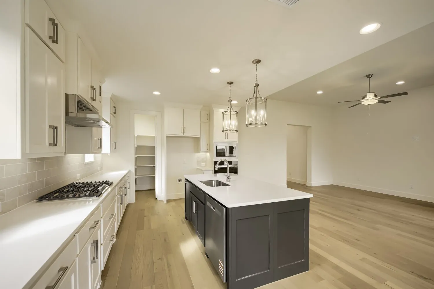 White cabinetry and light wood-finish flooring
