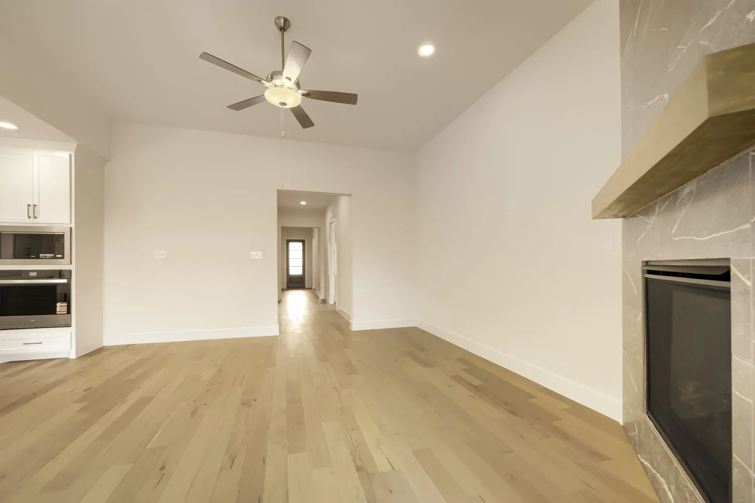 Vaulted ceiling with recessed lighting and a ceiling fan