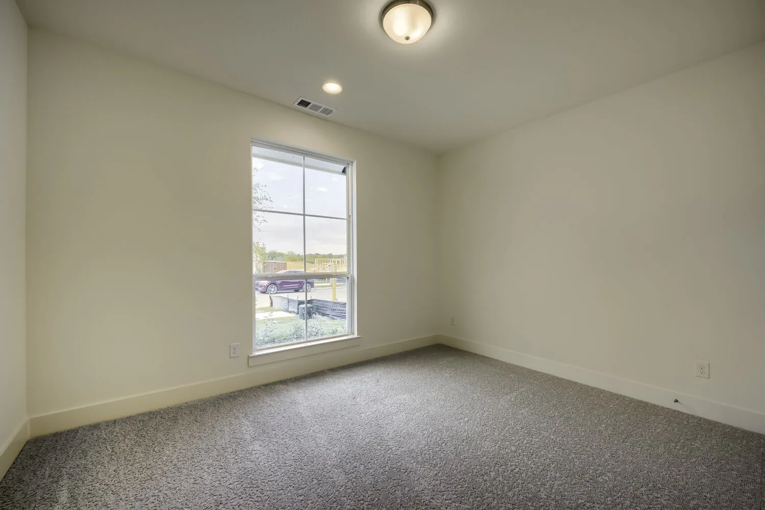 Neutral wall paint, recessed lighting, and a single ceiling fixture