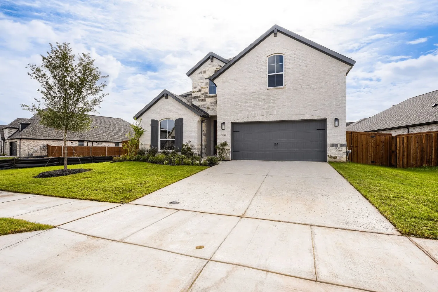 Stone and stucco exterior with dark trim accents