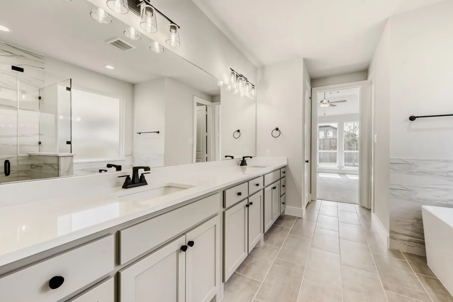 Dual vanity with quartz countertops, undermount sinks, and matte black fixtures