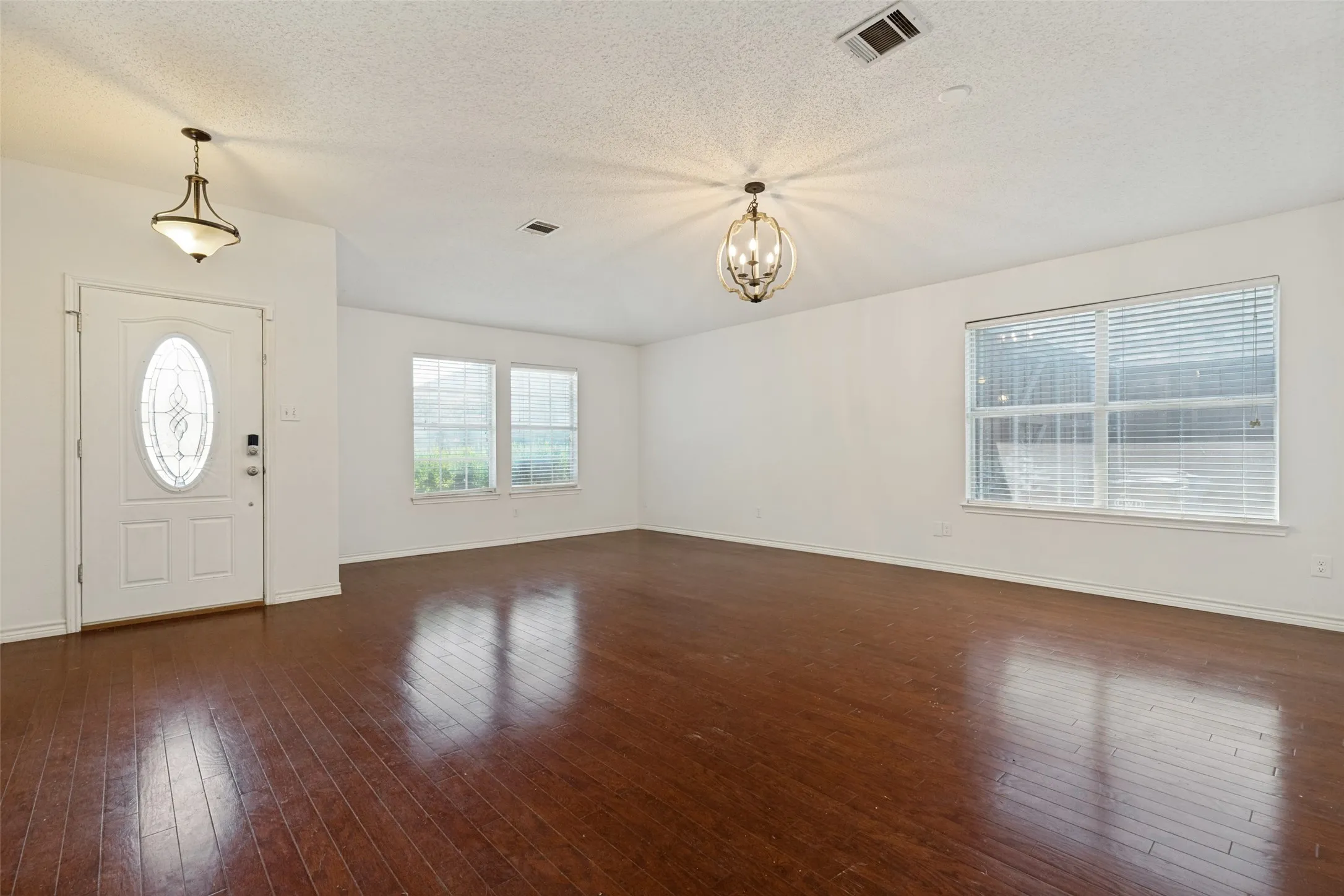 Rich wood-finish flooring complements the neutral wall tones