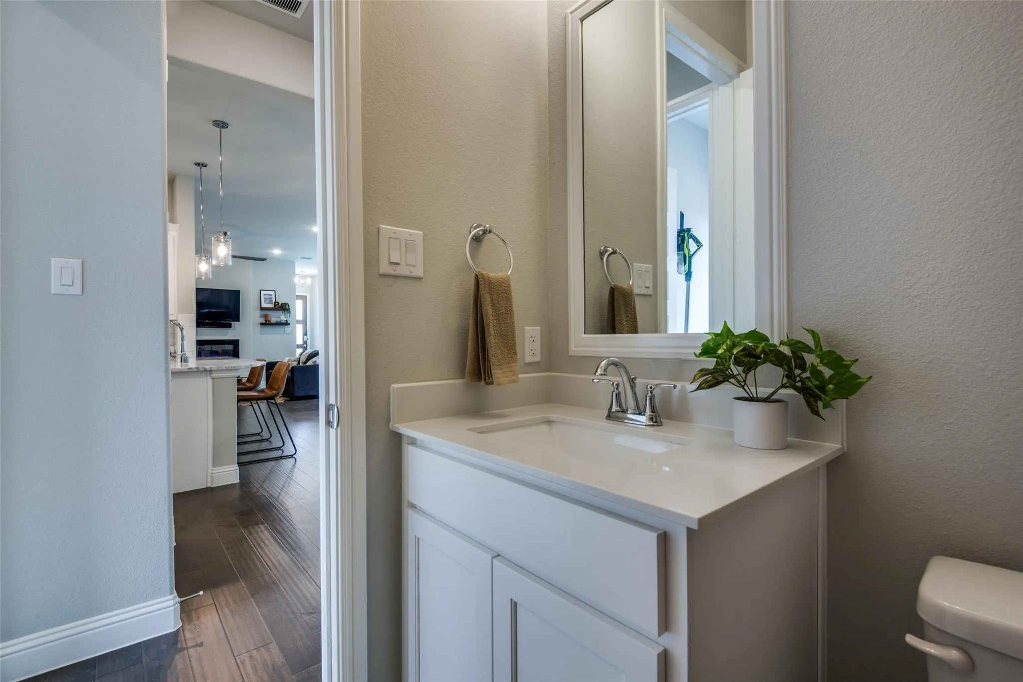 Elegant bathroom vanity featuring a white cabinetry base, quartz countertop, and chrome faucet