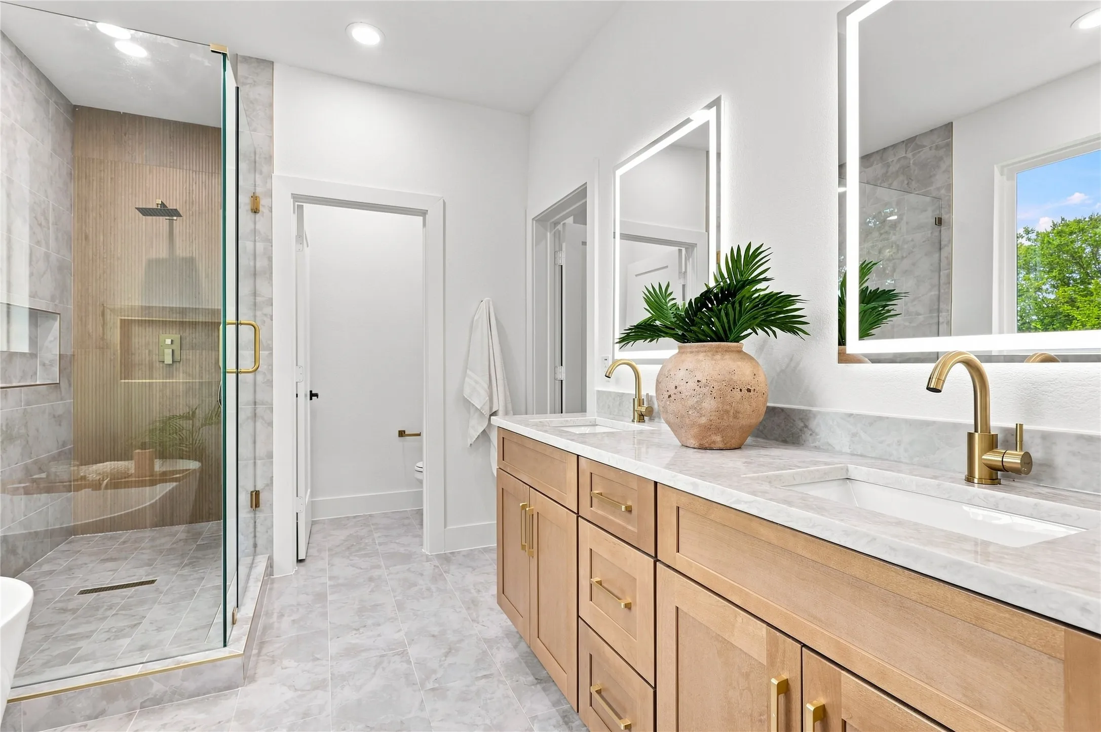 Unit B - Spacious Primary Bath featuring Dual Vanity, Freestanding Soaking Tub and Frameless Shower