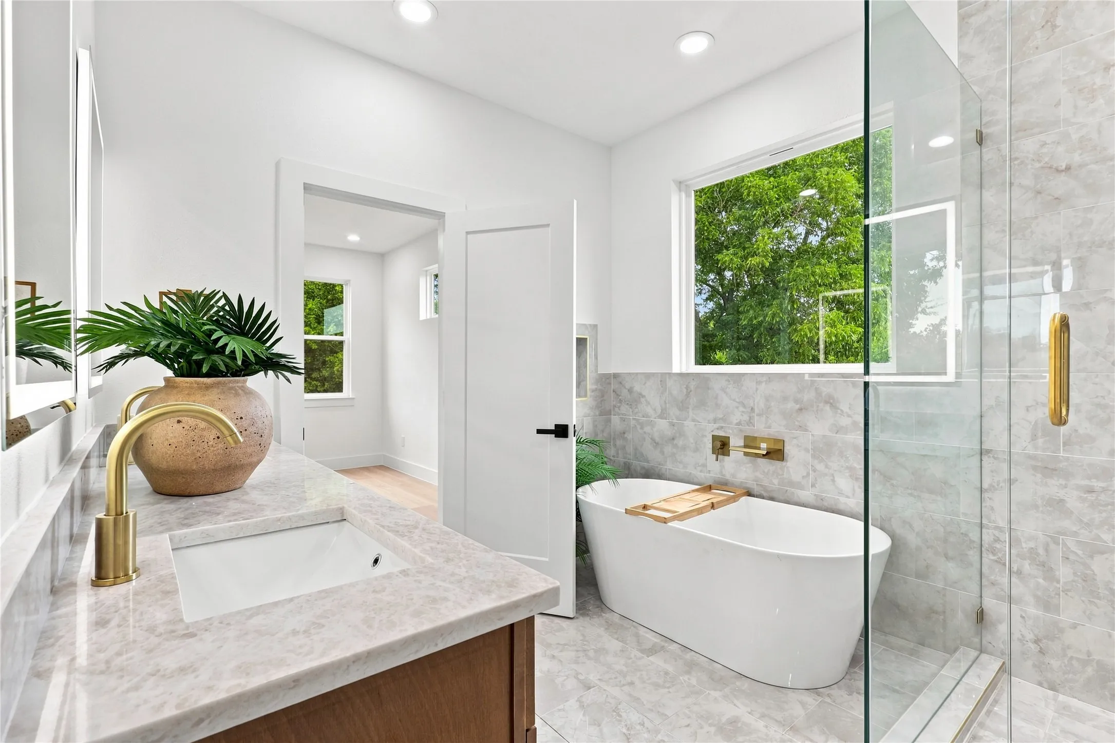 Unit B - Spacious Primary Bath featuring Dual Vanity, Freestanding Soaking Tub and Frameless Shower