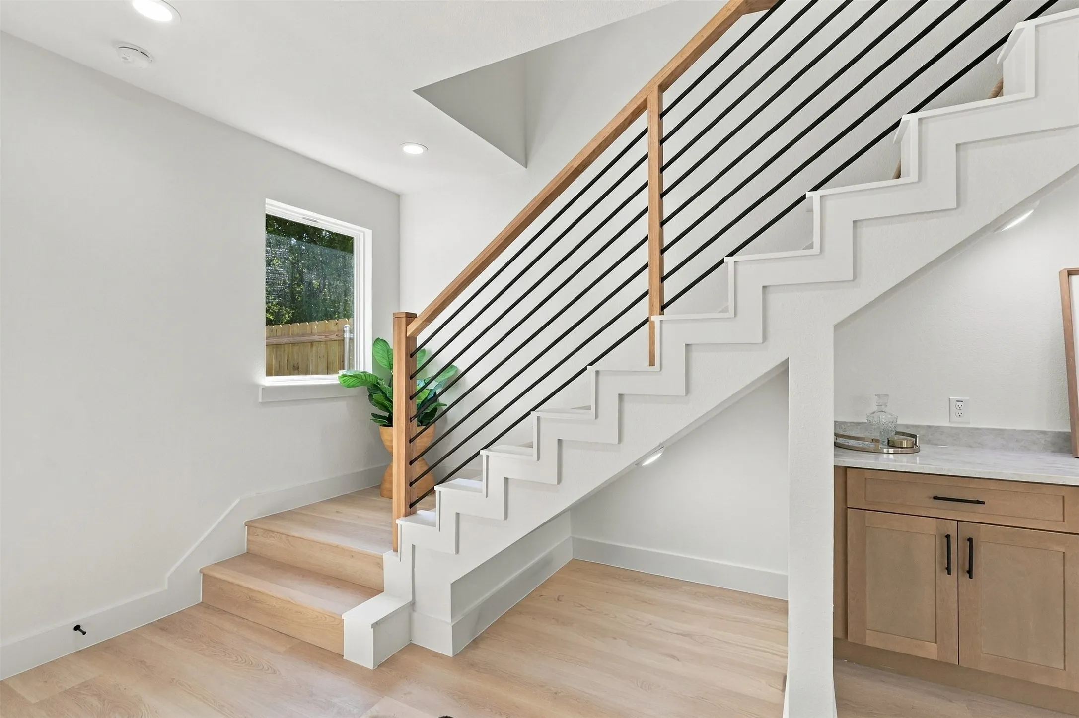 Unit A- Staircase from Living Room to Three Upstairs Ensuite Bedrooms and Laundry Room.