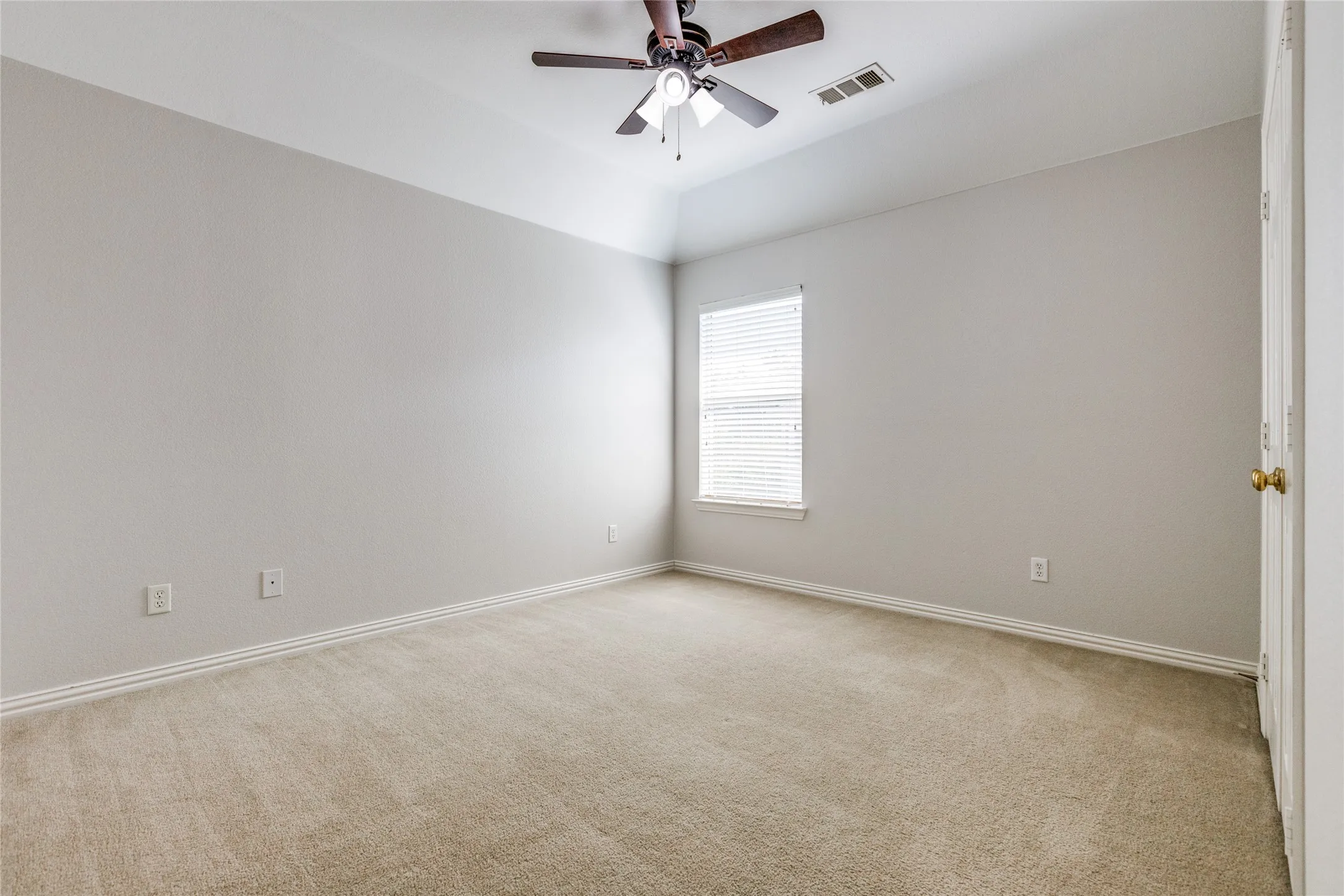 Room featuring light-toned carpeting, neutral wall paint, and white baseboards