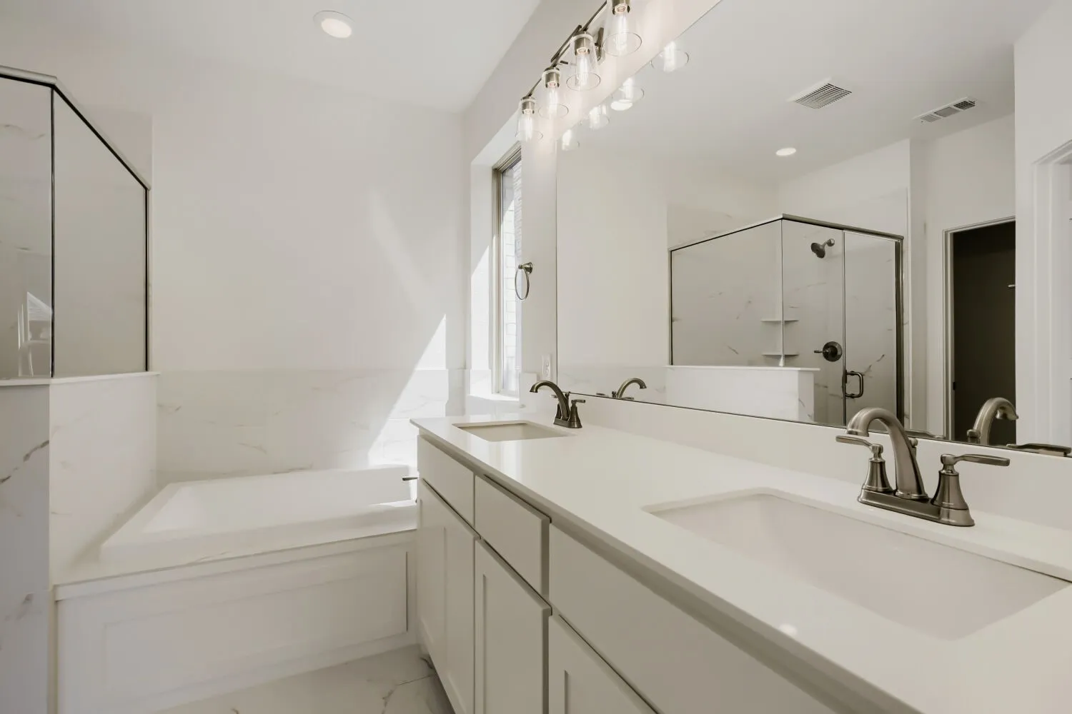 Double vanity with undermount sinks and brushed nickel faucets