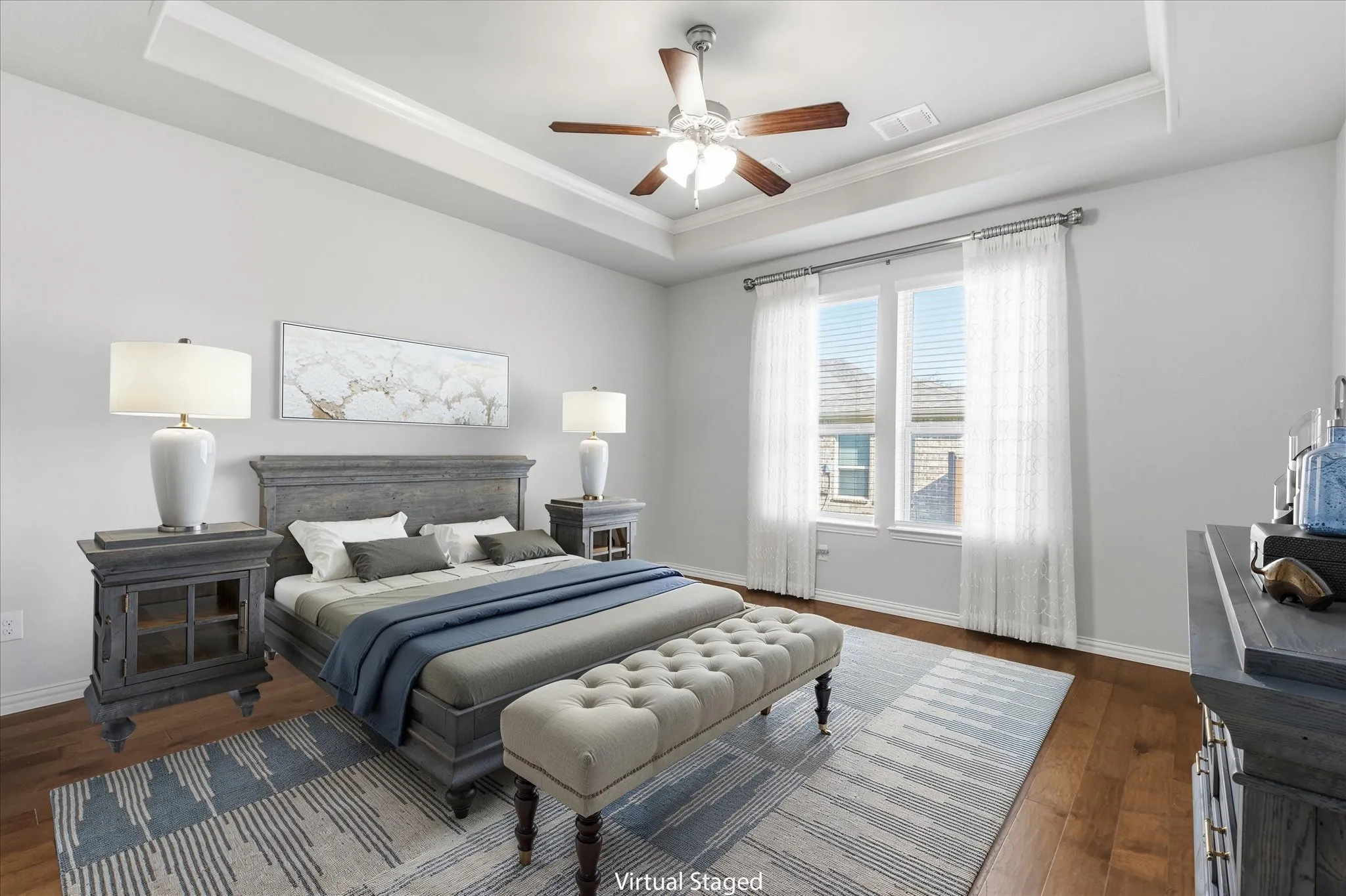 Virtual staging. Primary bedroom featuring a coffered ceiling with recessed lighting, ceiling fan with integrated light fixture, and hardwood flooring