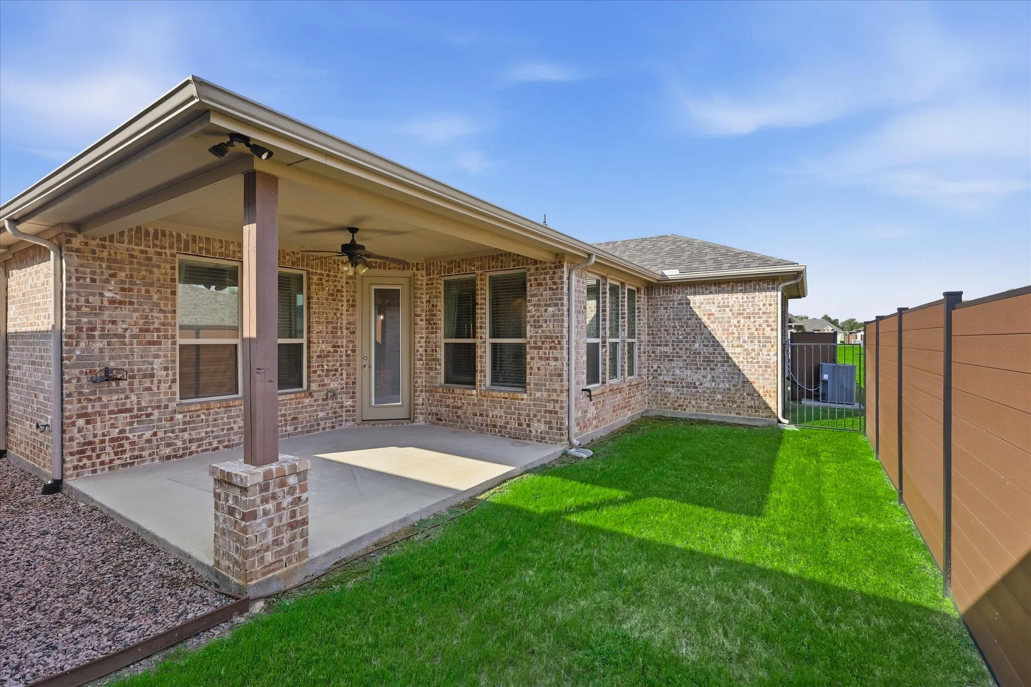 Covered patio featuring a ceiling fan and recessed lighting, overlooking a green lawn