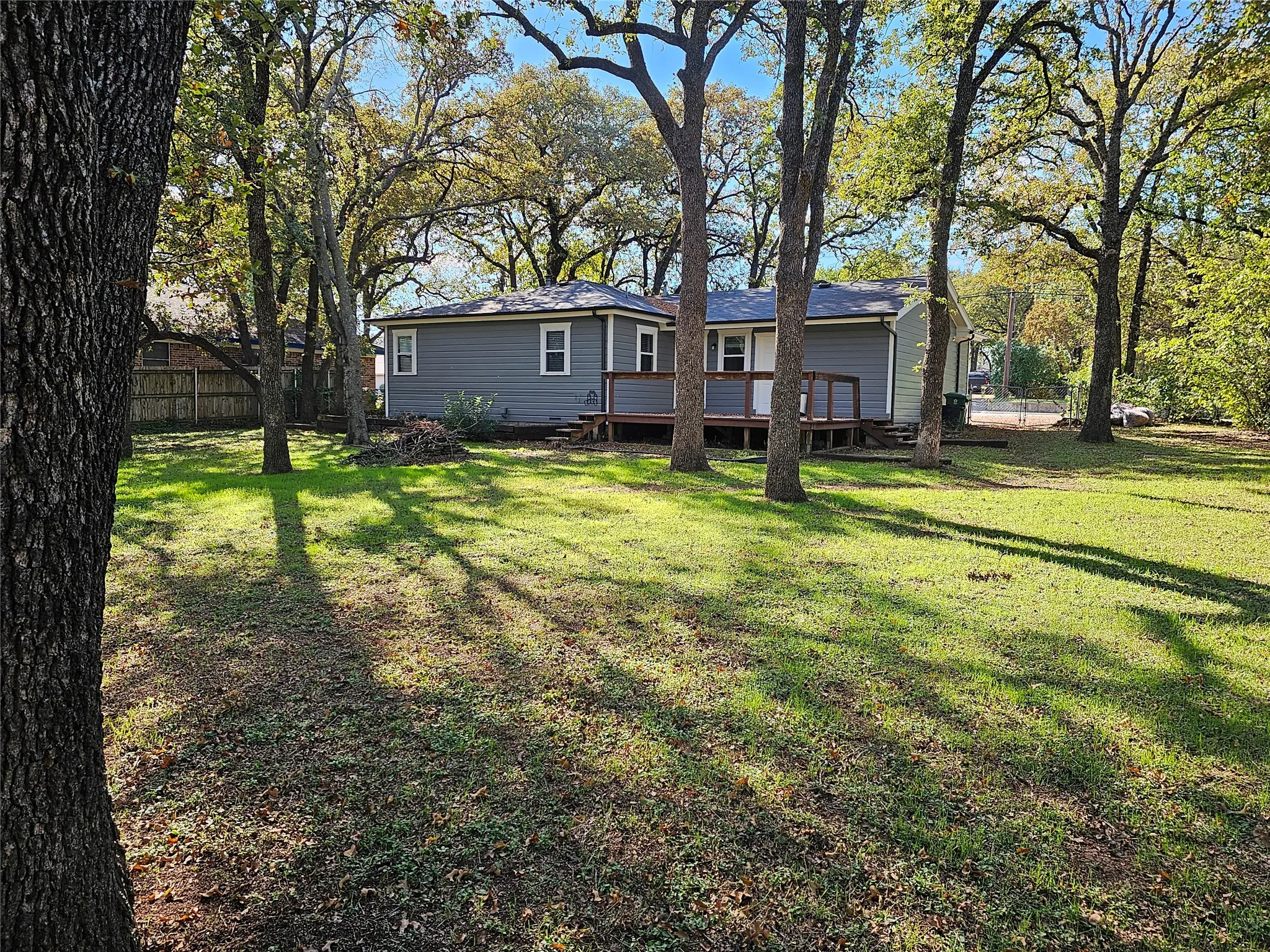 Charming single-story residence set on a spacious, tree-lined lot featuring mature oak trees providing natural shade throughout the property