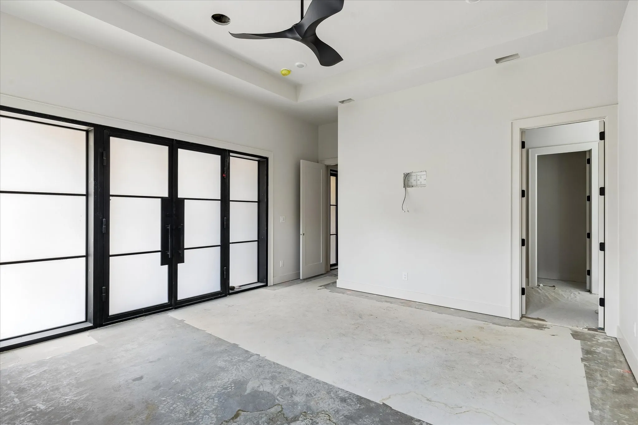 Second Primary Bedroom with doors leading to outdoor living area and backyard