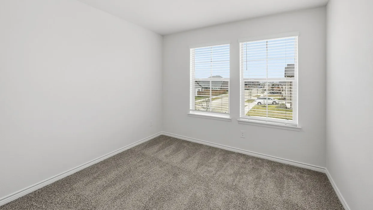 Neutral-toned wall-to-wall carpeting complements the bright white walls and trim
