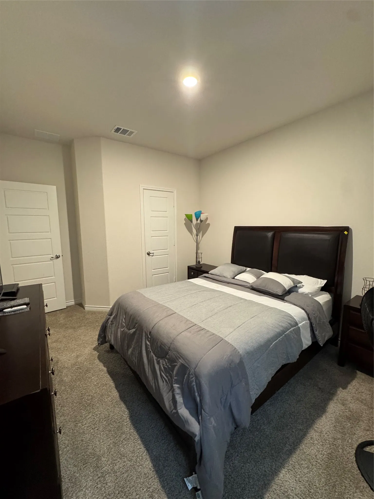 Bedroom with carpet floors and baseboards