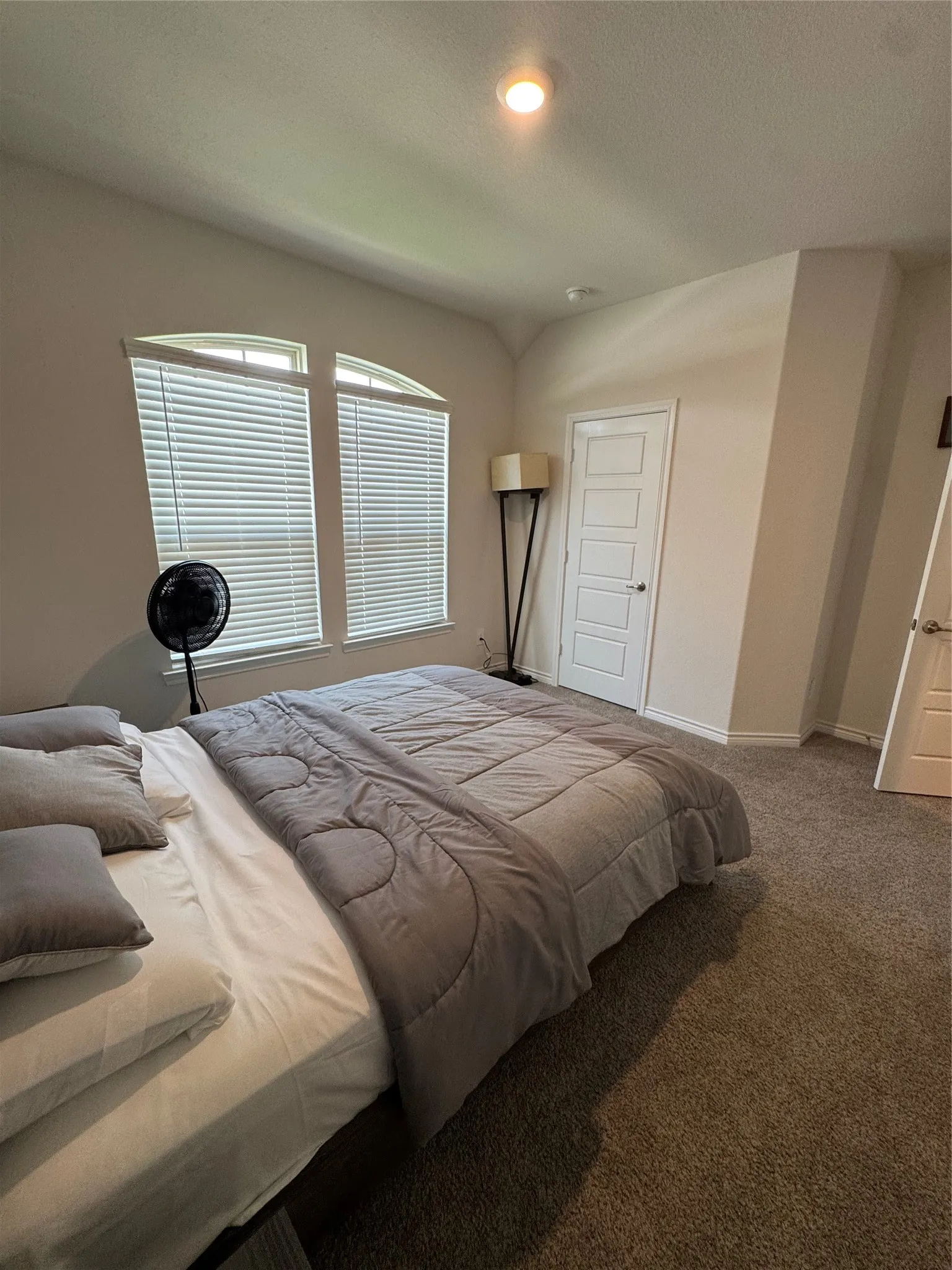 Bedroom featuring carpet floors and baseboards