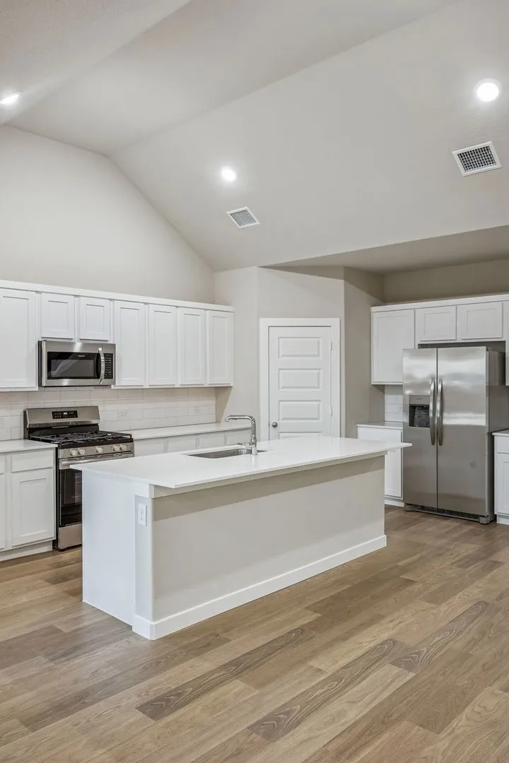 Kitchen in the Wimbledon home plan by Trophy Signature Homes – REPRESENTATIVE PHOTO