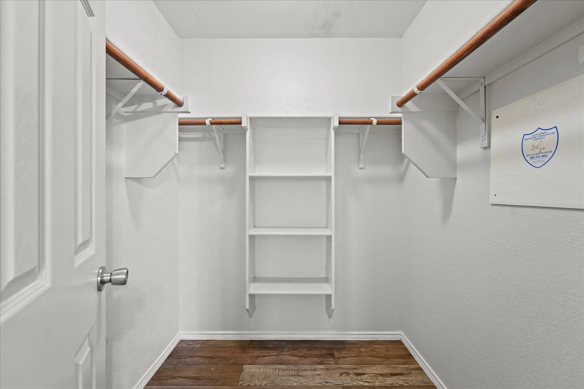 Walk in closet featuring dark wood-type flooring