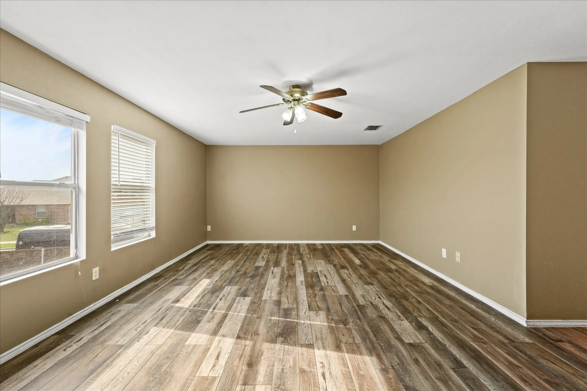 Unfurnished room with ceiling fan and wood finished floors