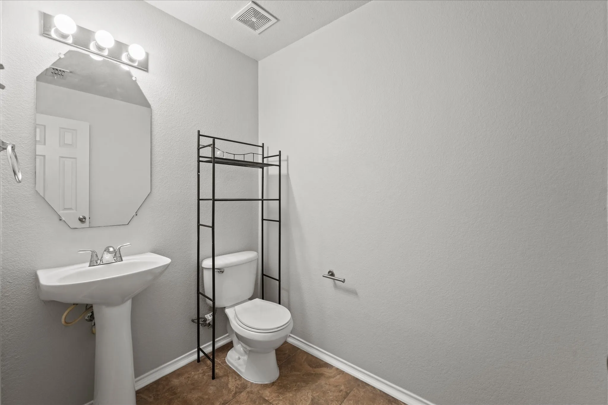 Half bathroom featuring toilet and baseboards